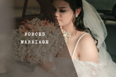 Young bride wearing a white veil and gown looking downward with a somber expression.